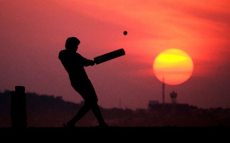 a man playing cricket in evening